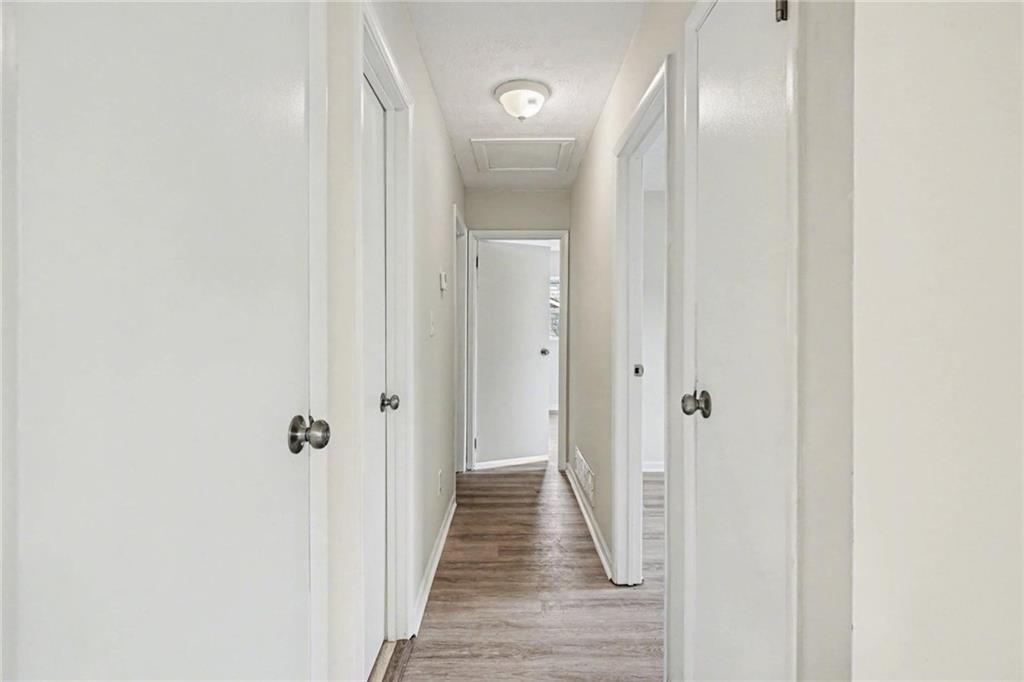 8355 Dunellen Lane Jonesboro, GA 30238 - Photo 17 of 27 a view of a hallway with wooden floor