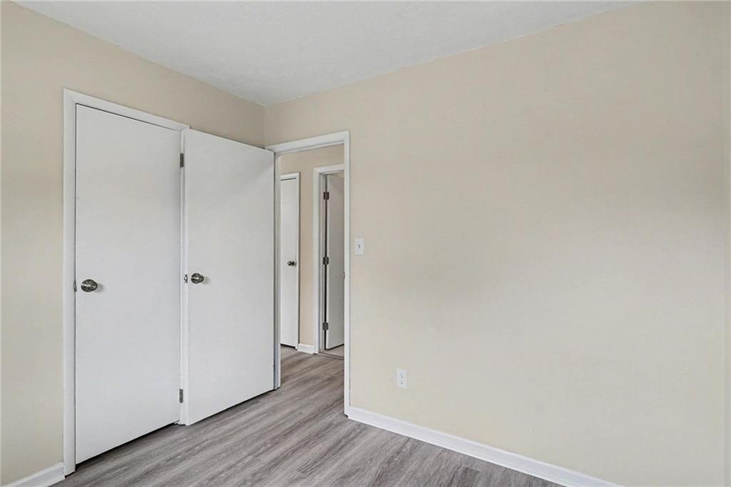 8355 Dunellen Lane Jonesboro, GA 30238 - Photo 19 of 27 a view of a hallway with wooden floor