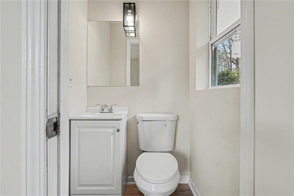 8355 Dunellen Lane Jonesboro, GA 30238 - Photo 26 of 27 a white toilet sitting next to a bathroom sink