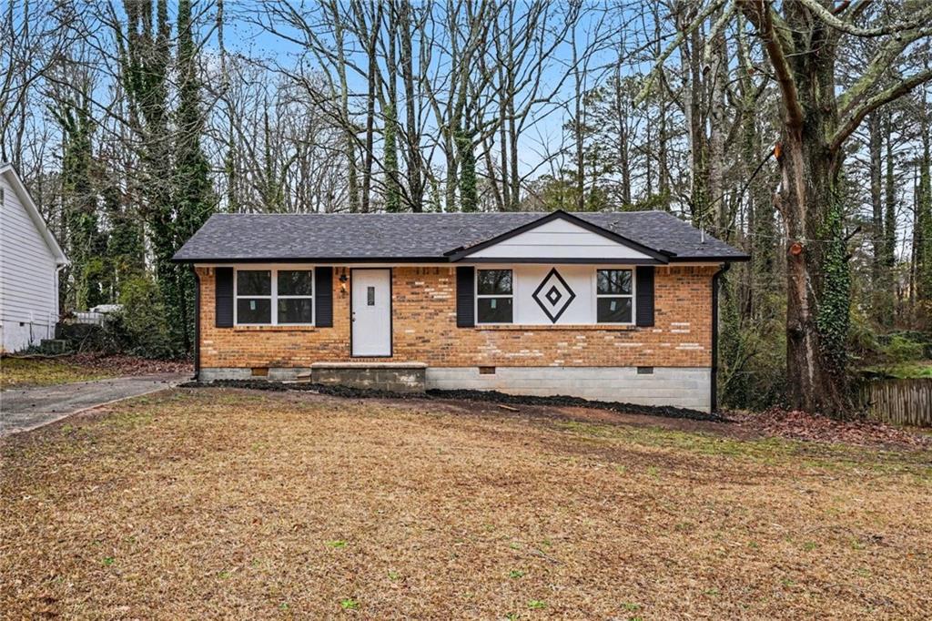 8355 Dunellen Lane Jonesboro, GA 30238 - Photo 7 of 27 a front view of a house with a garden