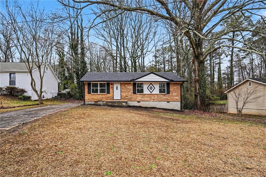 8355 Dunellen Lane Jonesboro, GA 30238 - Photo 8 of 27 a front view of a house with a yard