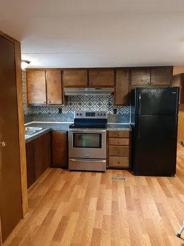 a kitchen with stainless steel appliances a stove and a refrigerator
