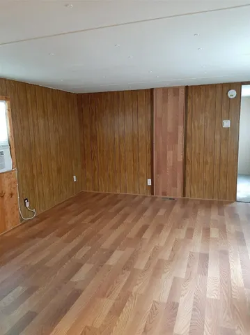 a view of an empty room and wooden floor