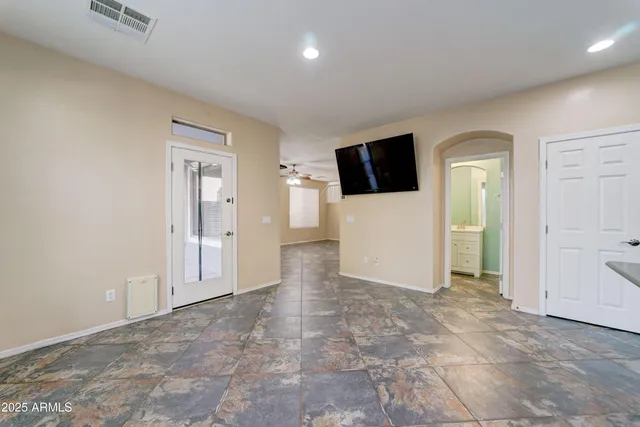 a view of a livingroom with wooden floor and a flat screen tv
