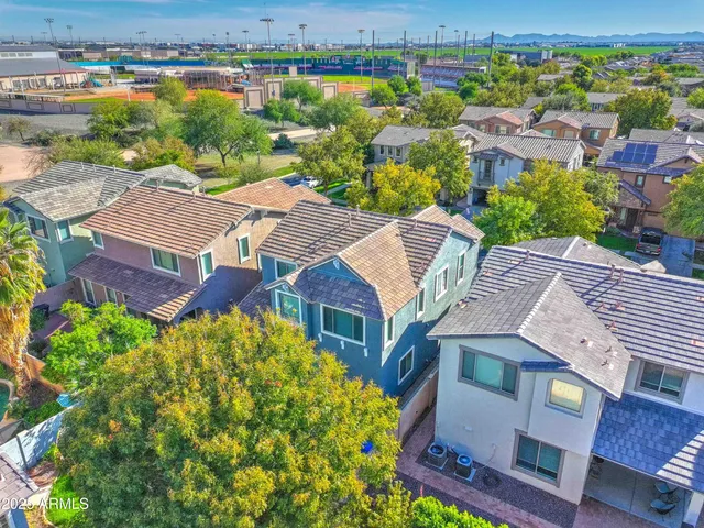 an aerial view of residential houses with outdoor space and river view
