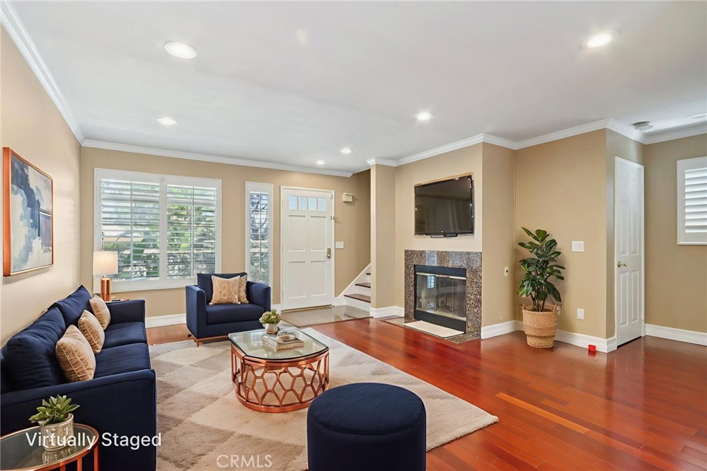 a living room with fireplace furniture and a flat screen tv