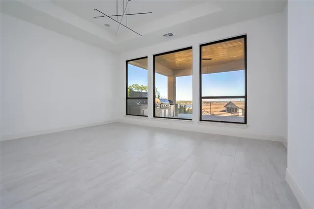 an empty room with windows and closet