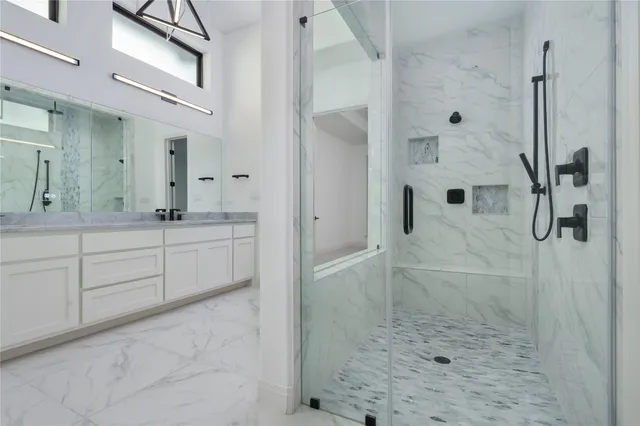 a bathroom with a shower sink and mirror