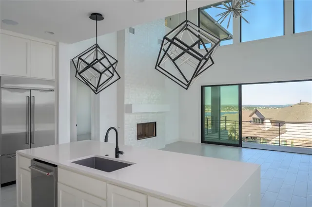 a kitchen with stainless steel appliances a sink a stove and a window