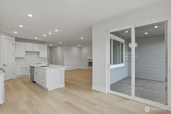 a large kitchen with a large window and stainless steel appliances