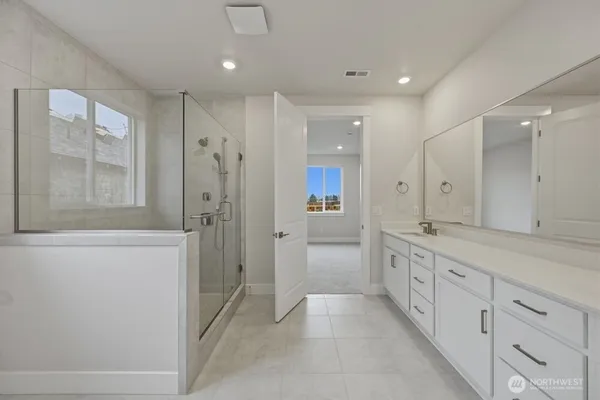 a bathroom with a granite countertop sink mirror and a shower