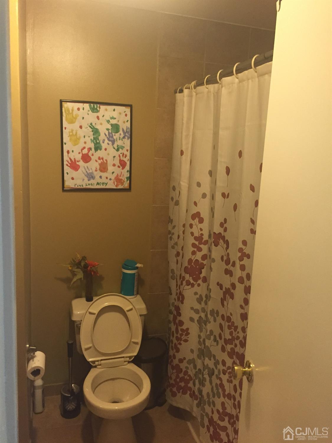 701 Jesse Way Piscataway, NJ 08854 - Photo 4 of 12 a white toilet sitting next to a shower curtain