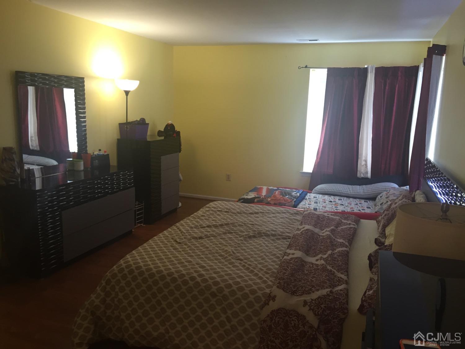 701 Jesse Way Piscataway, NJ 08854 - Photo 6 of 12 a bedroom with a bed and a mirror