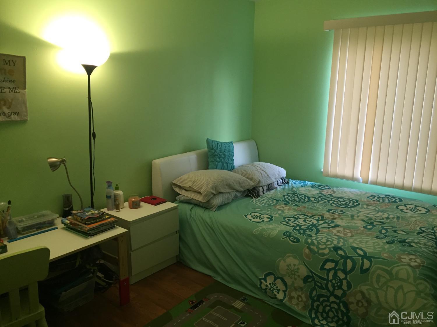 701 Jesse Way Piscataway, NJ 08854 - Photo 7 of 12 a bedroom with a bed a lamp and a window