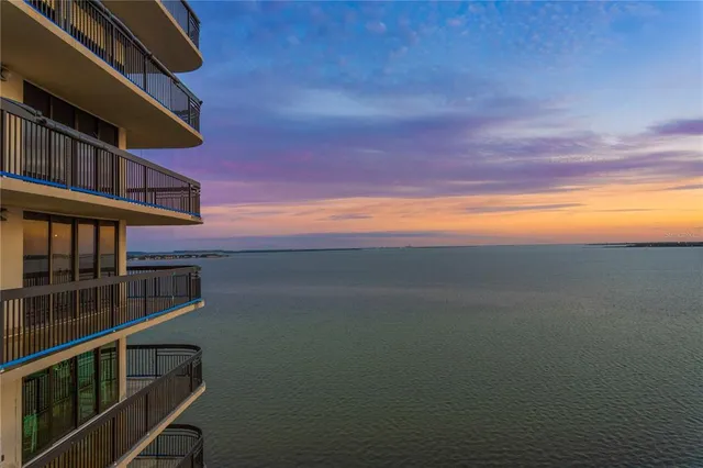 a bedroom with a bed a lamp and a large window