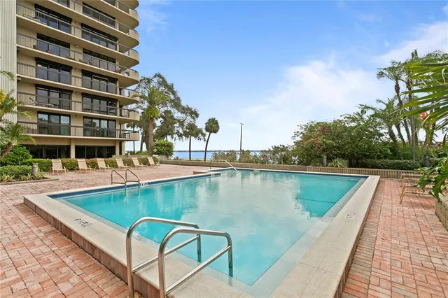 a view of swimming pool with outdoor seating and yard in back