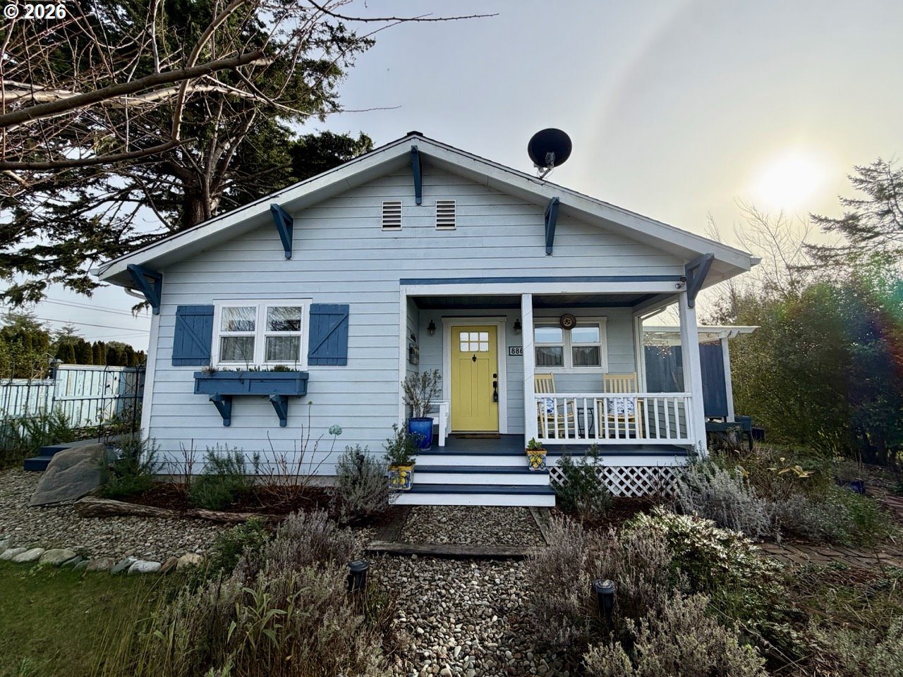 886 1st Street Southeast Bandon, OR 97411 - Photo 1 of 40 a front view of a house with garden