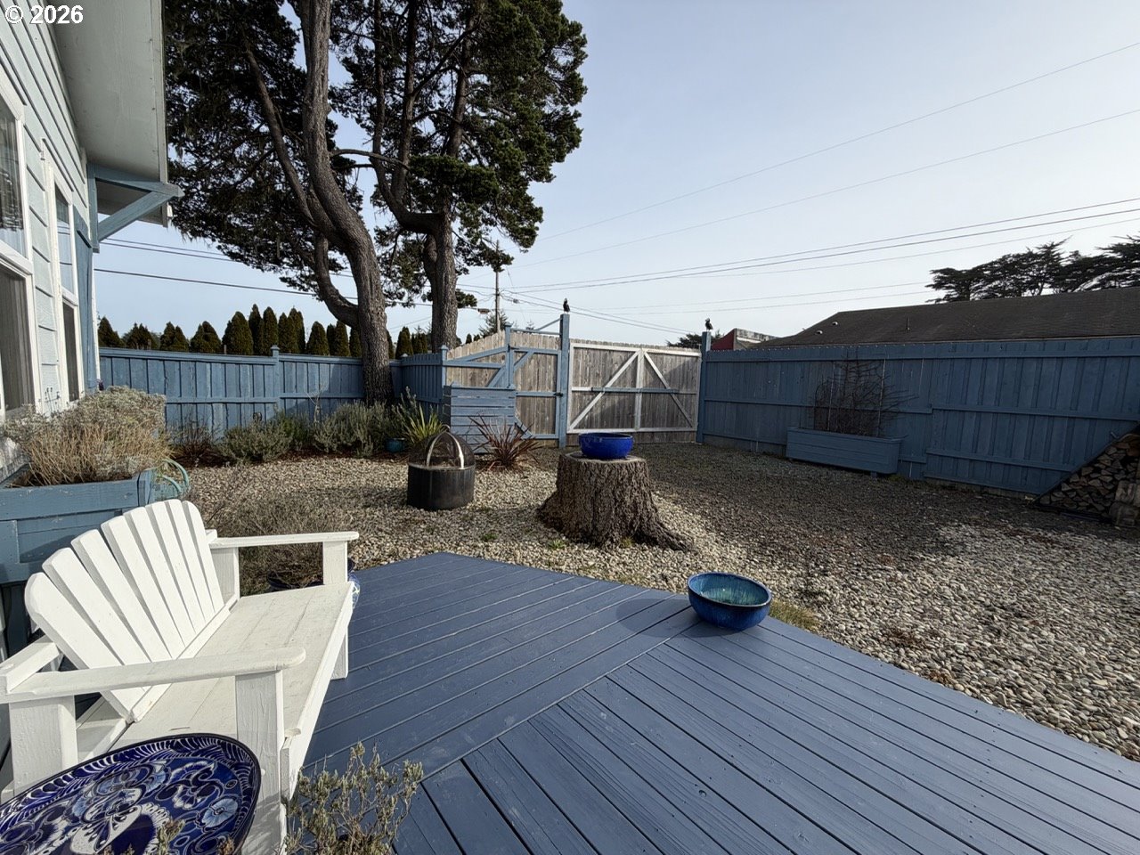 886 1st Street Southeast Bandon, OR 97411 - Photo 14 of 40 a view of a chair and tables on the wooden roof deck