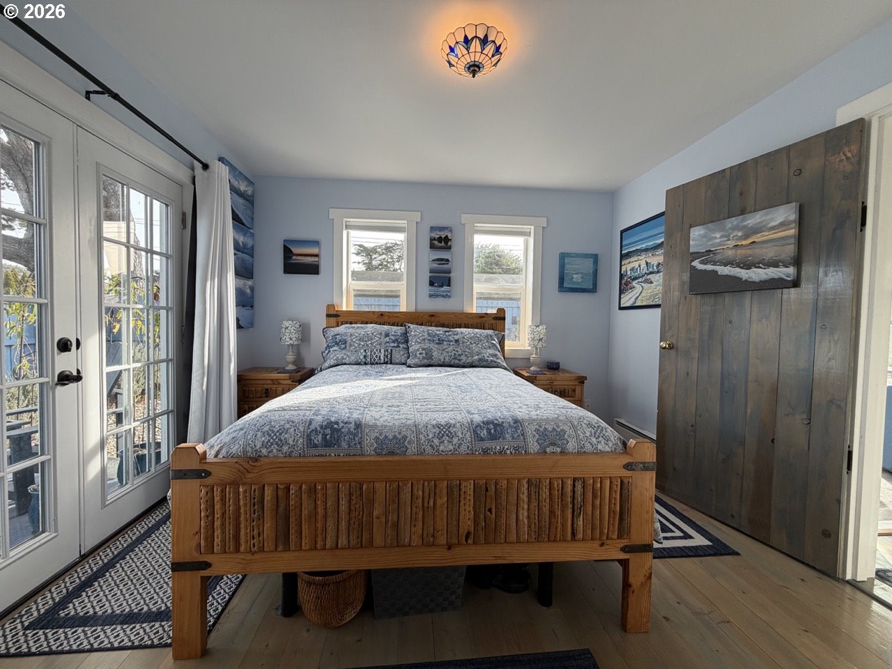 886 1st Street Southeast Bandon, OR 97411 - Photo 18 of 40 a bedroom with a bed and wooden floor