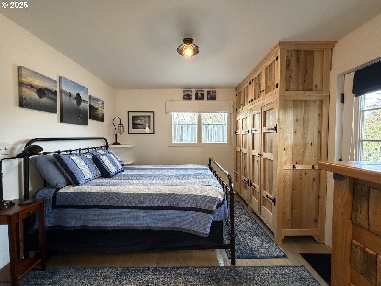 886 1st Street Southeast Bandon, OR 97411 - Photo 21 of 40 a bed sitting in a bedroom next to a window
