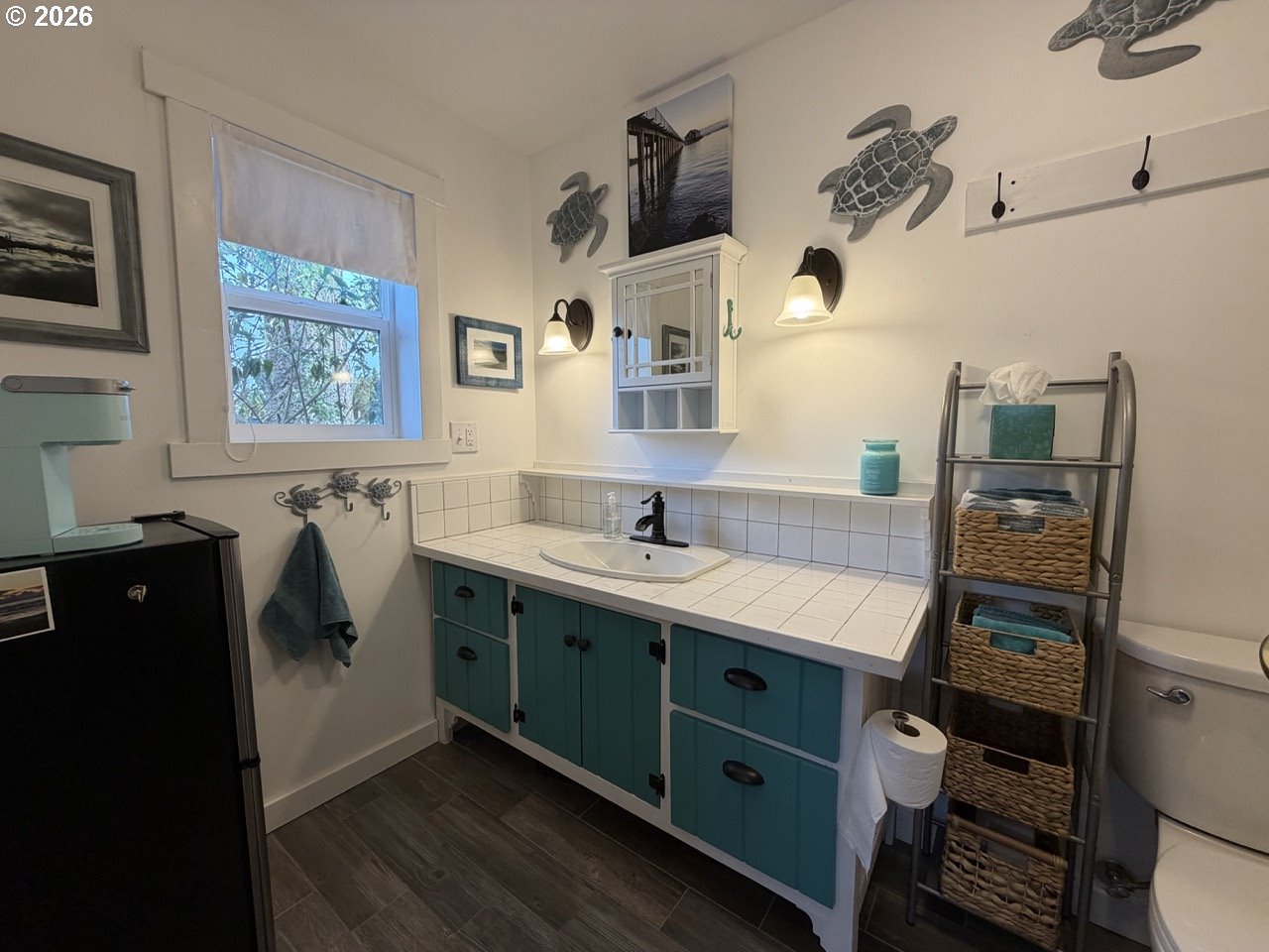 886 1st Street Southeast Bandon, OR 97411 - Photo 24 of 40 a bathroom with a sink a mirror and a toilet