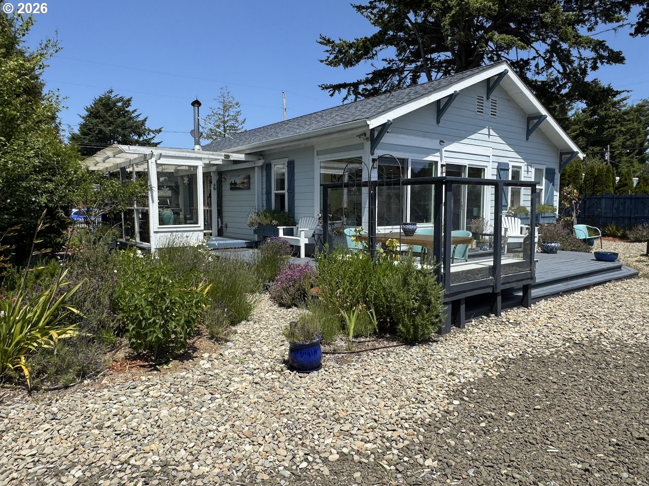 886 1st Street Southeast Bandon, OR 97411 - Photo 33 of 40 a front view of a house with a yard outdoor seating and entertaining space