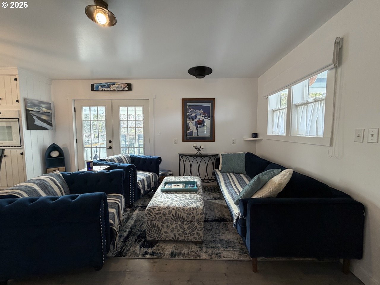 886 1st Street Southeast Bandon, OR 97411 - Photo 4 of 40 a living room with furniture and a chandelier