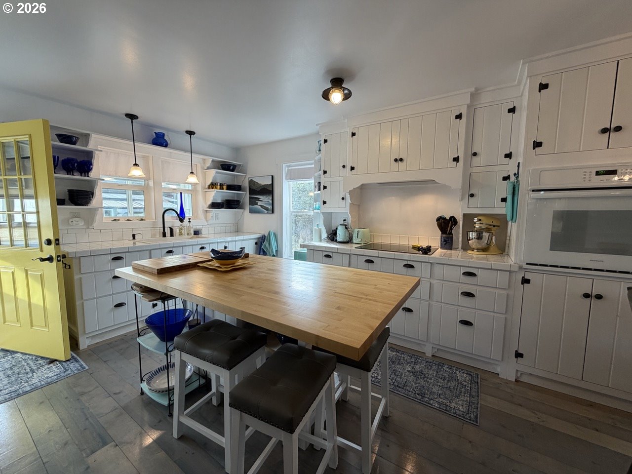 886 1st Street Southeast Bandon, OR 97411 - Photo 7 of 40 a room with stainless steel appliances kitchen island granite countertop a table chairs sink and cabinets