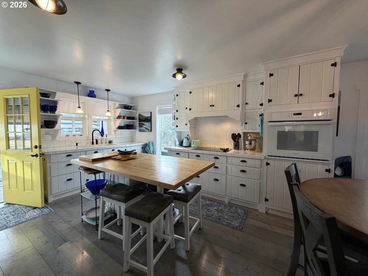 886 1st Street Southeast Bandon, OR 97411 - Photo 9 of 40 a kitchen with stainless steel appliances a table chairs and a refrigerator