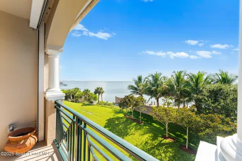 a view of a balcony with floor to ceiling windows with wooden floor
