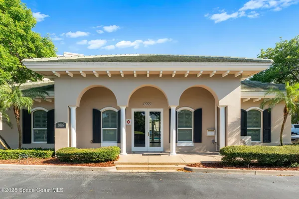 a view of a house with a fountain bath tub and potted plants