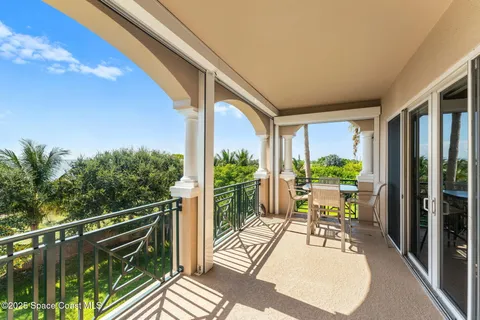 a view of balcony with wooden floor and outdoor seating