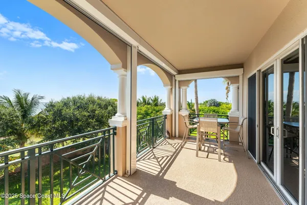 a view of balcony with wooden floor and outdoor seating