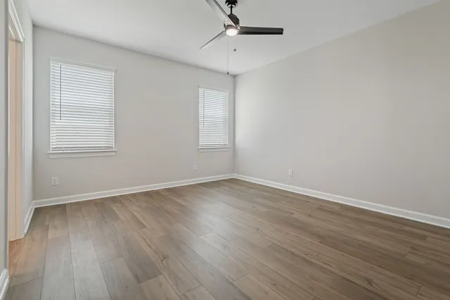 a view of a room with wooden floor and white walls