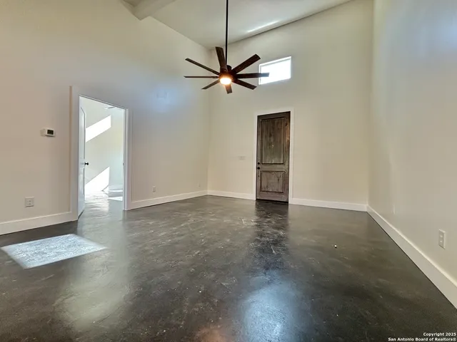an empty room with closet and a chandelier fan