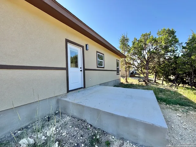 a view of a backyard with large trees
