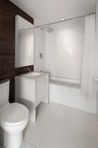 a kitchen with stainless steel appliances granite countertop a sink and a refrigerator