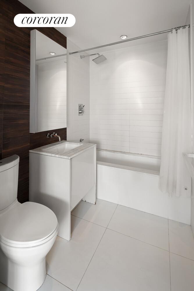 2 Northside Piers, Unit 7D Brooklyn, NY 11249 - Photo 5 of 17 a bathroom with a sink a toilet and shower