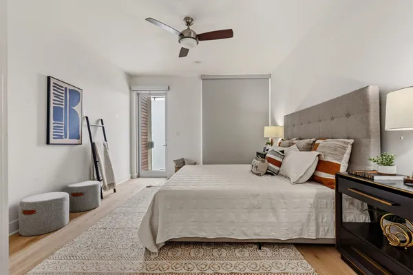 a bedroom with a bed a couch and a dresser