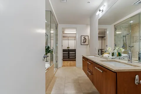 a spacious bathroom with a granite countertop sink and a mirror