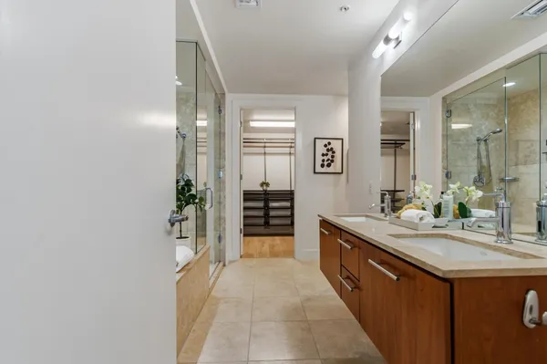 a spacious bathroom with a granite countertop sink and a mirror