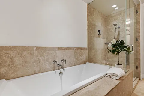 a bathroom with a tub and shower