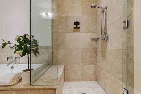 a bathroom with a shower a mirror and a sink