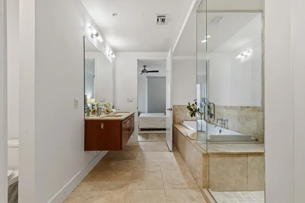 a large bathroom with a double vanity sink a large mirror and a shower