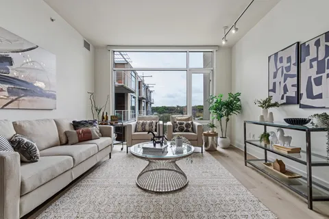 a living room with furniture a window and a table