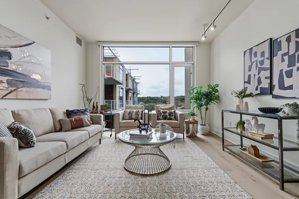 a living room with furniture a window and a table