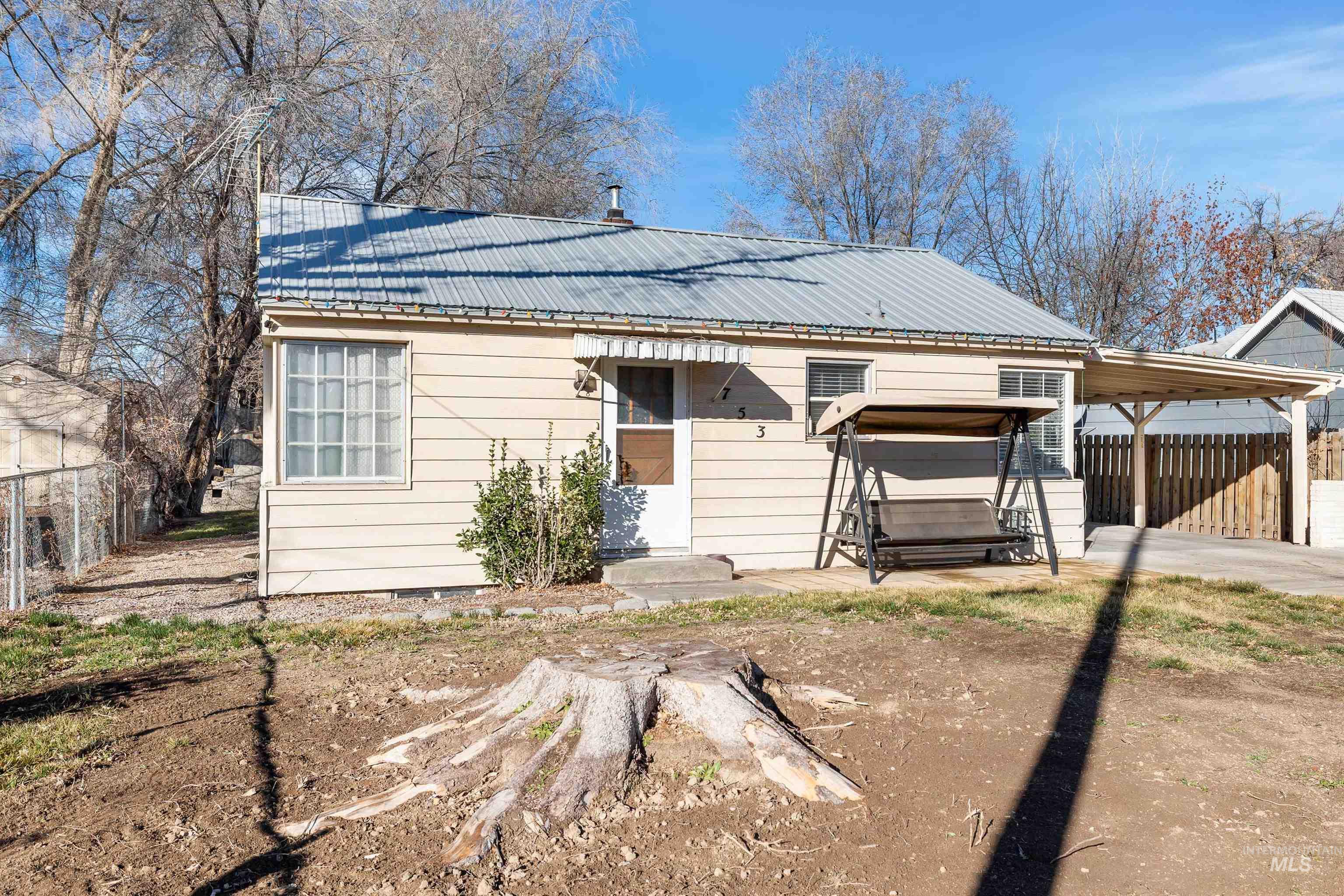 753 Ash Street Twin Falls, ID 83301 - Photo 2 of 25 View of front of house featuring an attached carport, a metal roof, concrete driveway, and crawl space