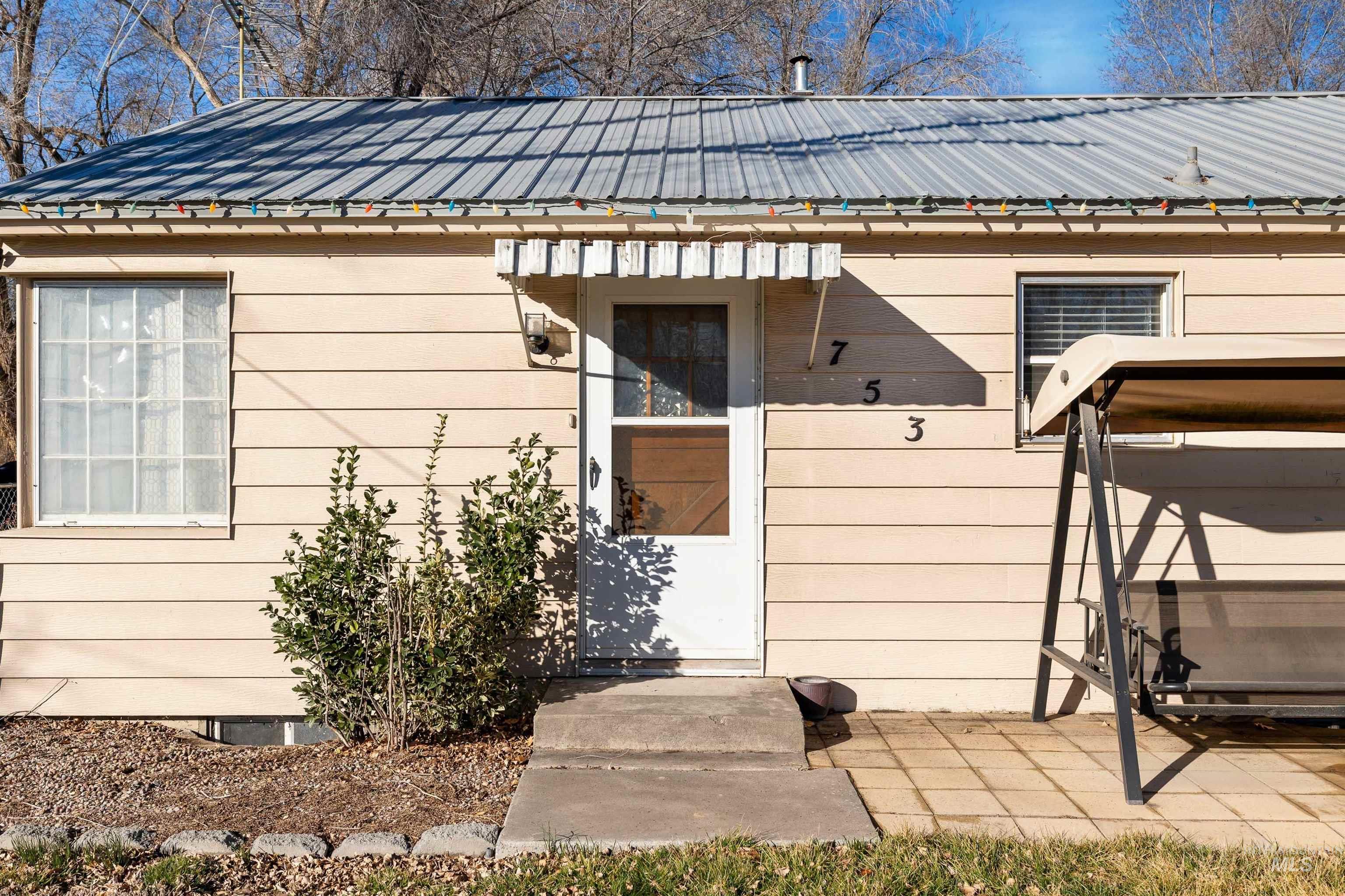 753 Ash Street Twin Falls, ID 83301 - Photo 3 of 25 View of exterior entry with a metal roof