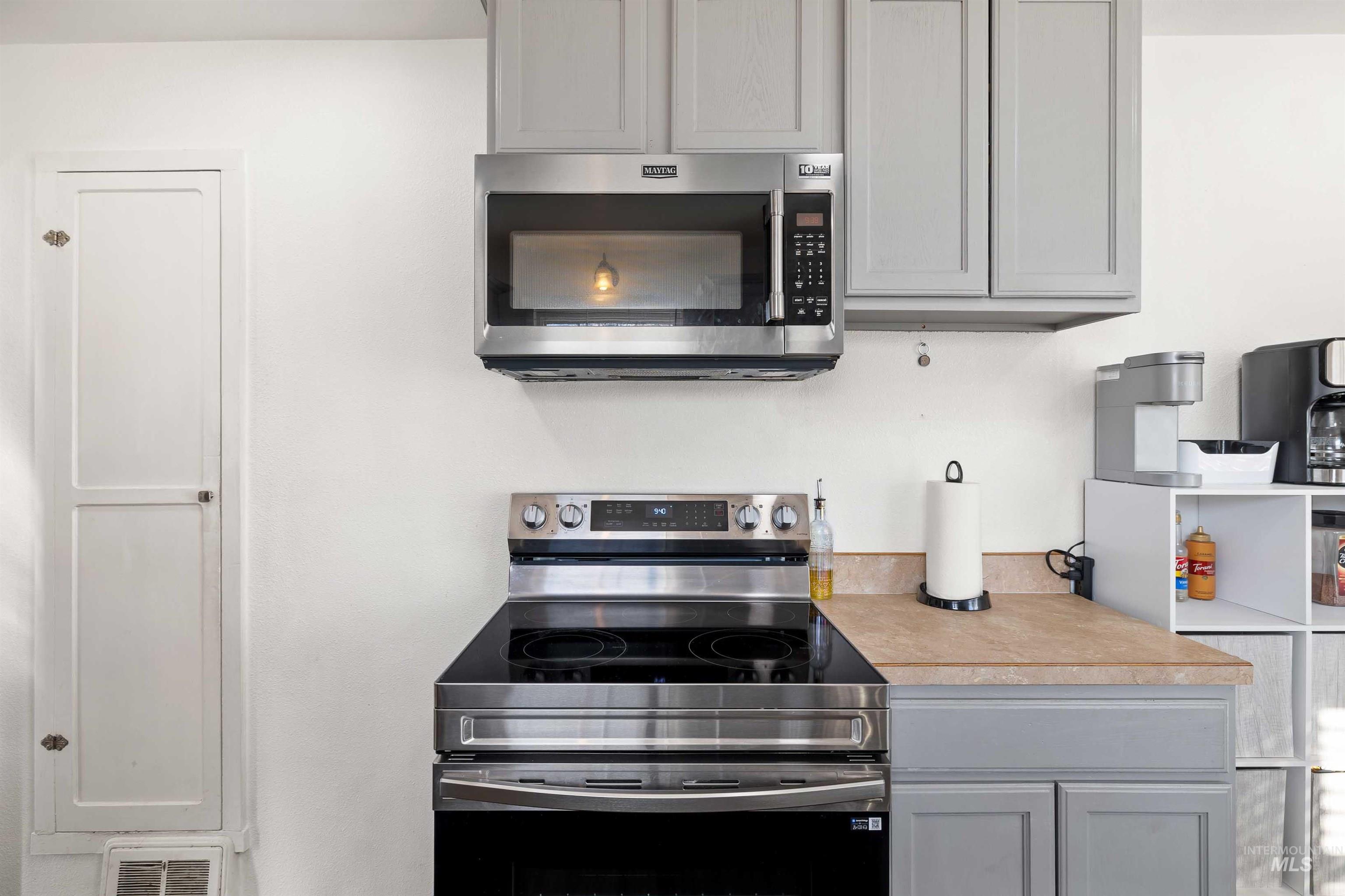 753 Ash Street Twin Falls, ID 83301 - Photo 8 of 25 Kitchen featuring gray cabinetry, stainless steel appliances, and light countertops