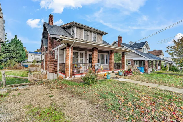 a living room with furniture a large window and a chandelier